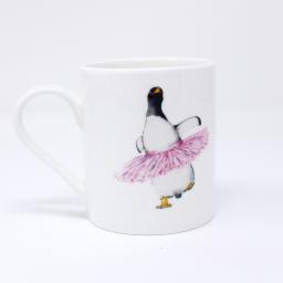 A gentoo penguin wearing a pink tutu on an espresso mug - handle facing left