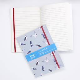 A notebook with elasticated enclosure with a sea birds design showing open pages