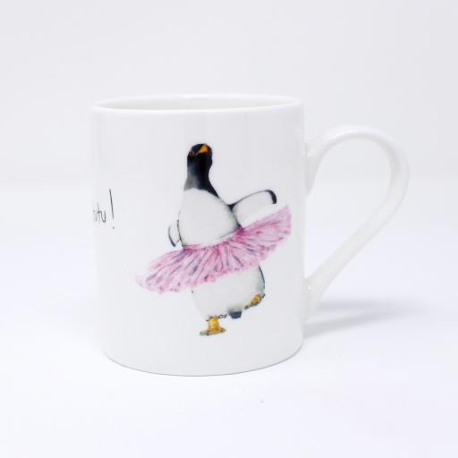 A gentoo penguin wearing a pink tutu on an espresso mug - handle facing right