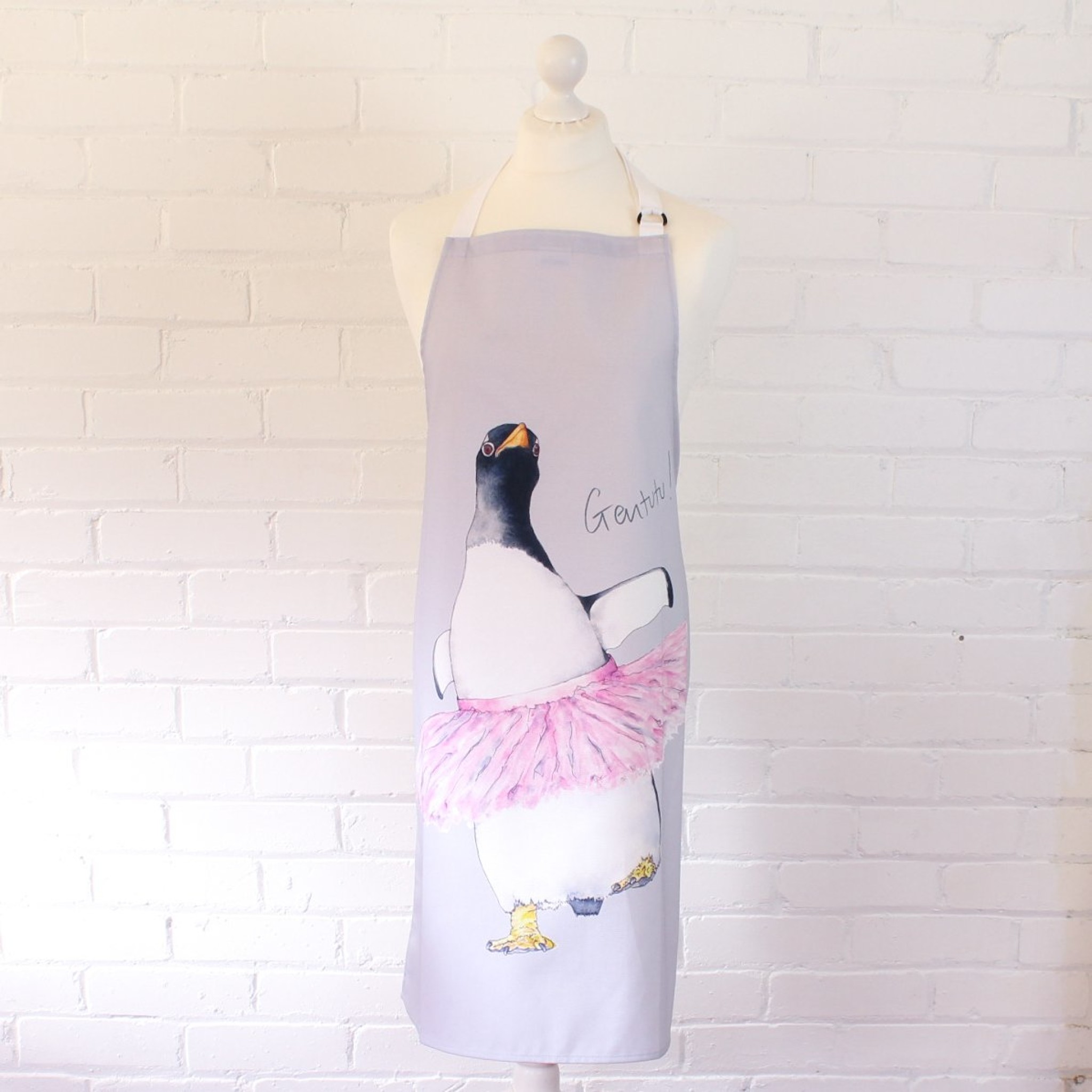 An apron featuring a gentoo penguin wearing a pink tutu